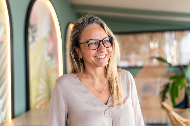 Smiling mature woman wearing glasses, looking away, reflecting on happiness