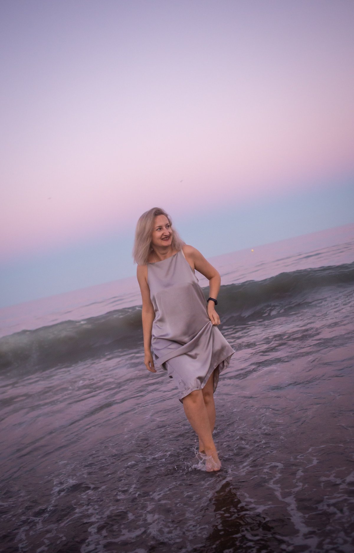 Woman walking freely by the ocean