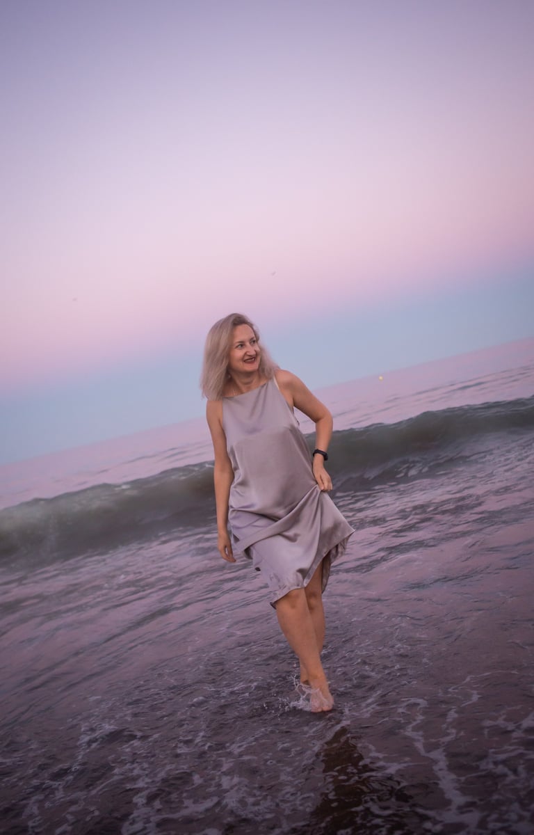 Woman walking freely by the ocean