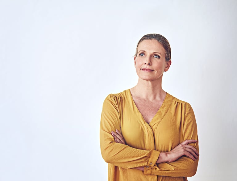Shot of an attractive and mature woman looking thoughtful against a grey background